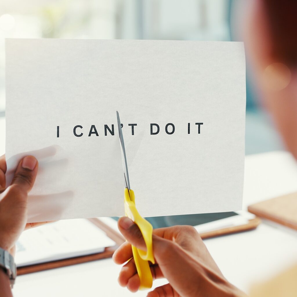 Cutting, paper and scissors with business person in office to destroy doubt or negative thought. Ch