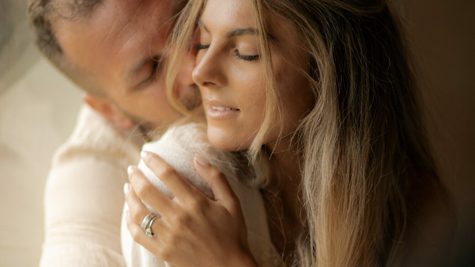 Love, young man hugs his girlfriend with passion and enjoys Valentine's Day.