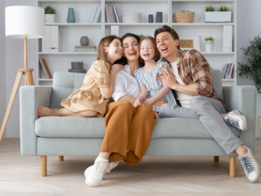 Happy family! Two children daughters with mother and father. Mum, dad and girls laughing and hugging.