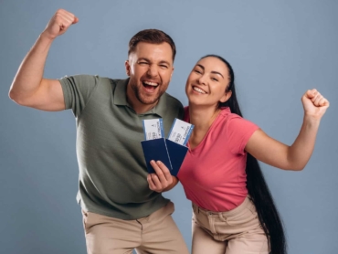 Very excited about vacation, with tickets. Man and woman are in the studio.