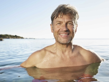 Portrait of smiling man bathing in the sea