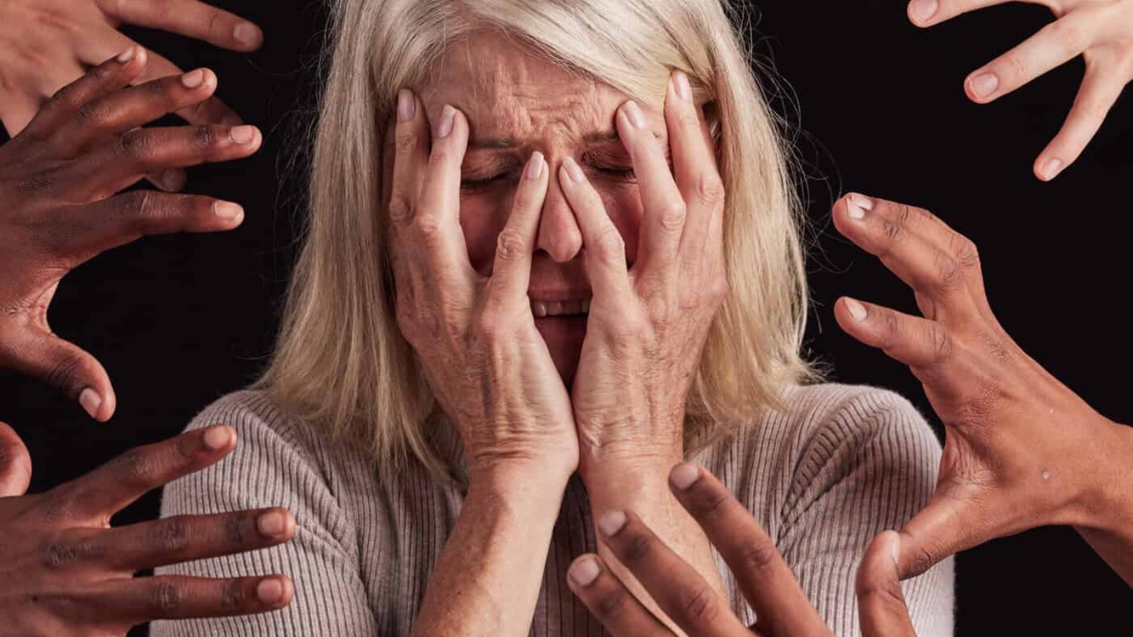 Senior woman, hands or mental health stress on black background in studio with guilt, fear or schiz.